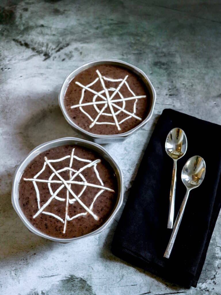easy halloween food idea for kids: black bean soup with sour cream spiderweb