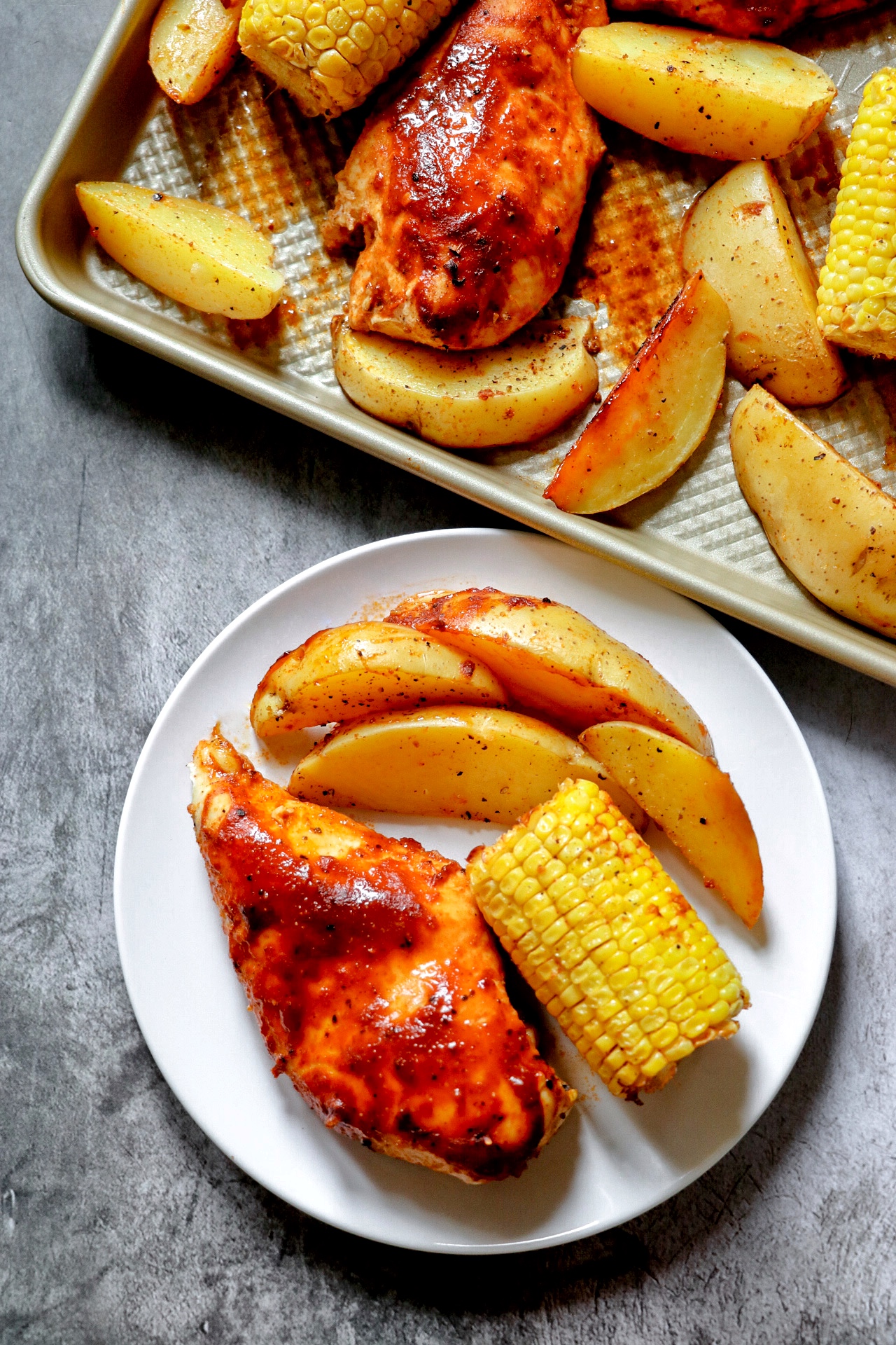 sheet pan baked barbecue chicken breasts with potatoes and corn