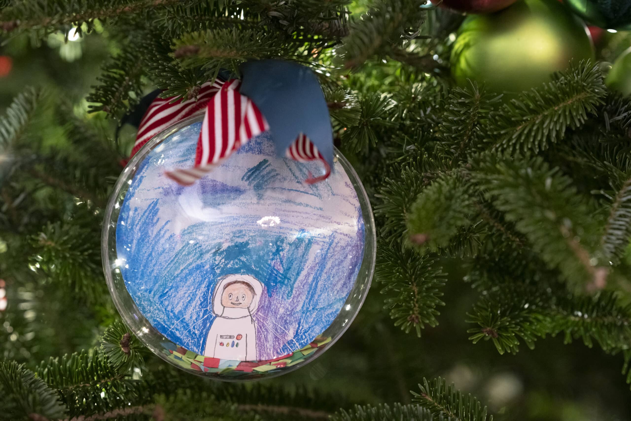 Kid's Self-Portrait ornaments in the State Dining Room as part of the 2022 White House holiday decorations
