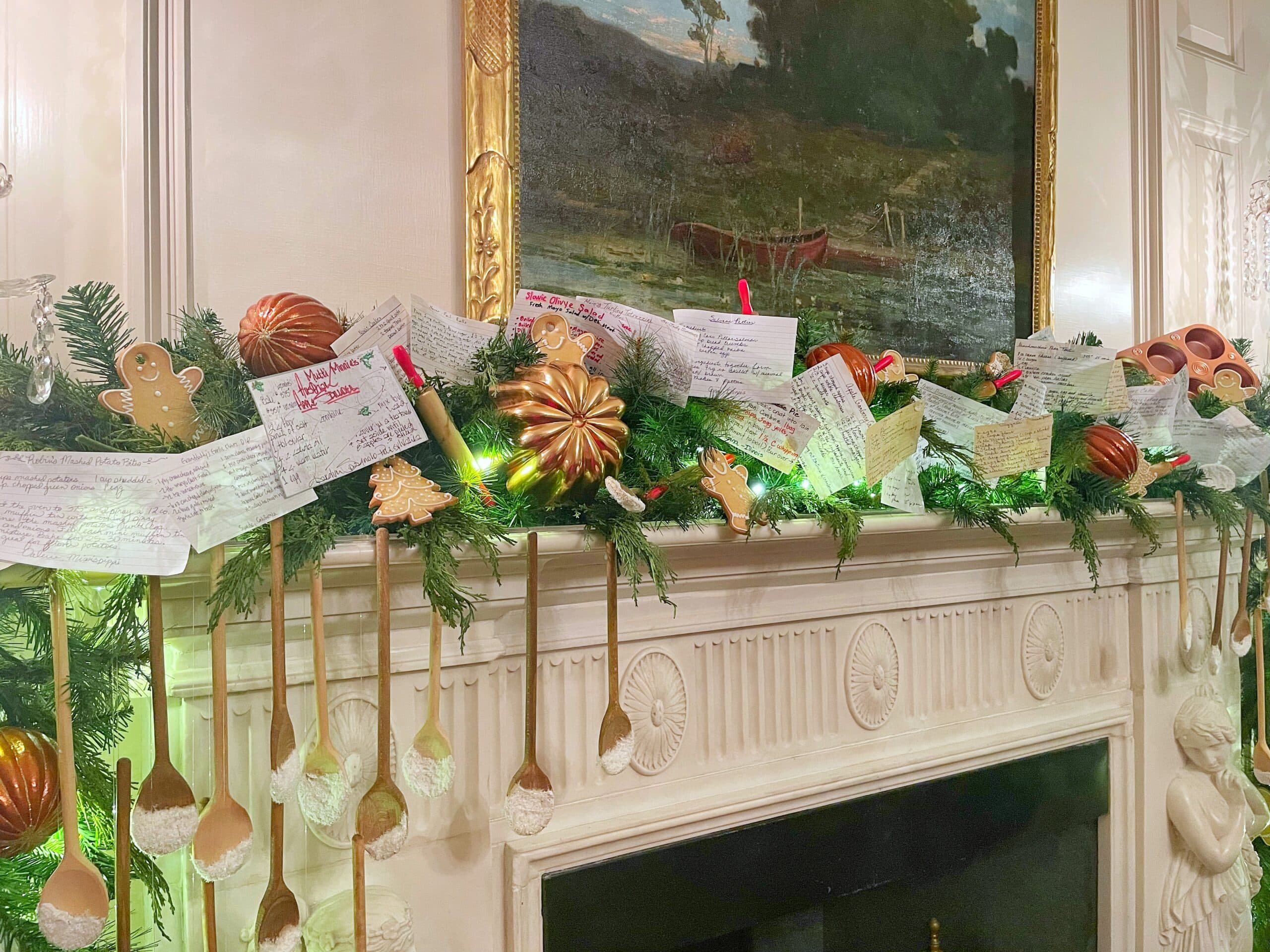 DIY recipe card garland and other food and cooking related Christmas decorations on the mantel of the White House China Room as part of the 2022 holiday decorations